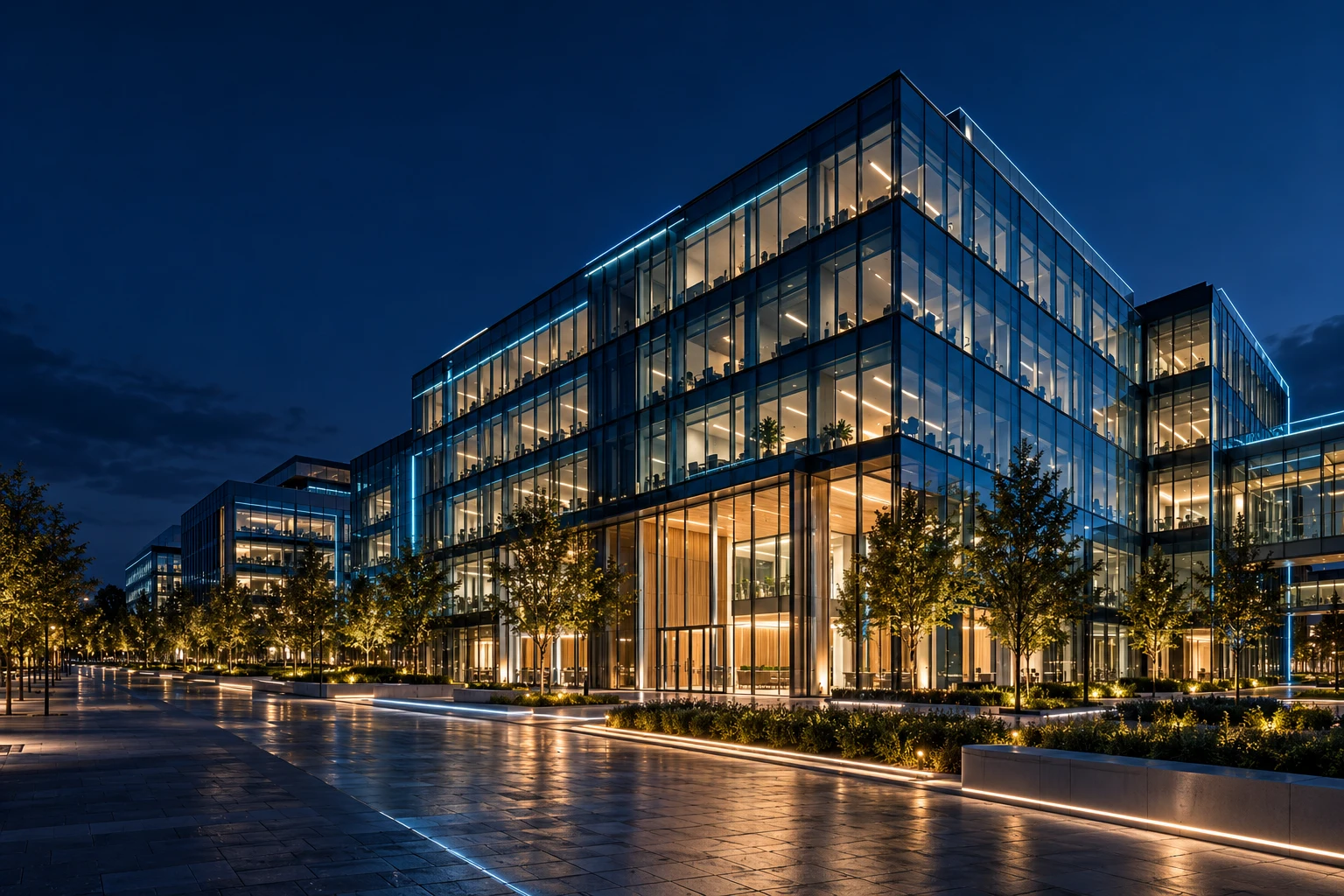 Modern glass buildings illuminated at blue hour